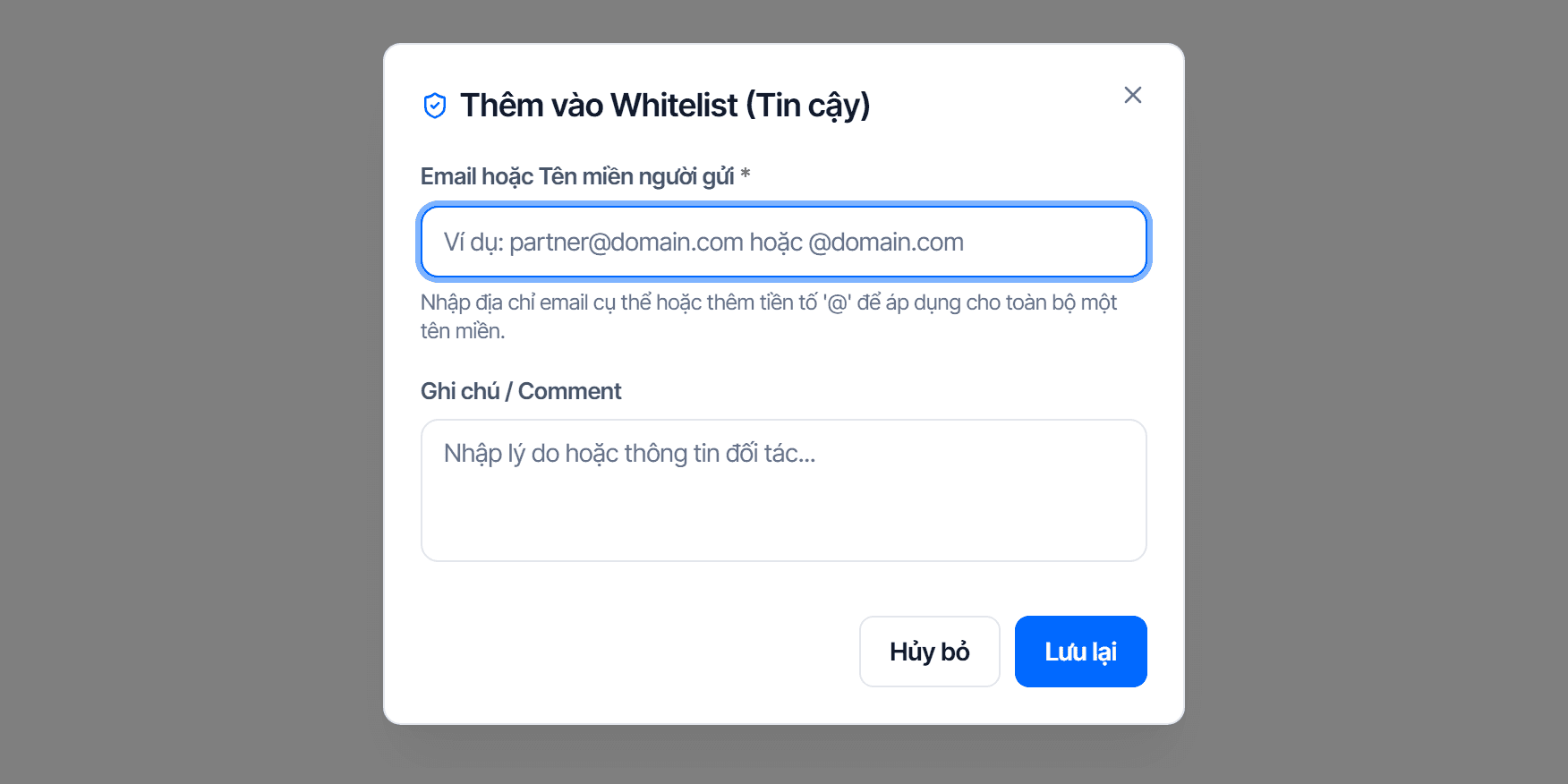 Hộp thoại Thêm vào Whitelist (Tin cậy): ô Email hoặc Tên miền người gửi kèm gợi ý nhập @ để áp cho cả tên miền, ô Ghi chú / Comment, và hai nút Hủy bỏ, Lưu lại