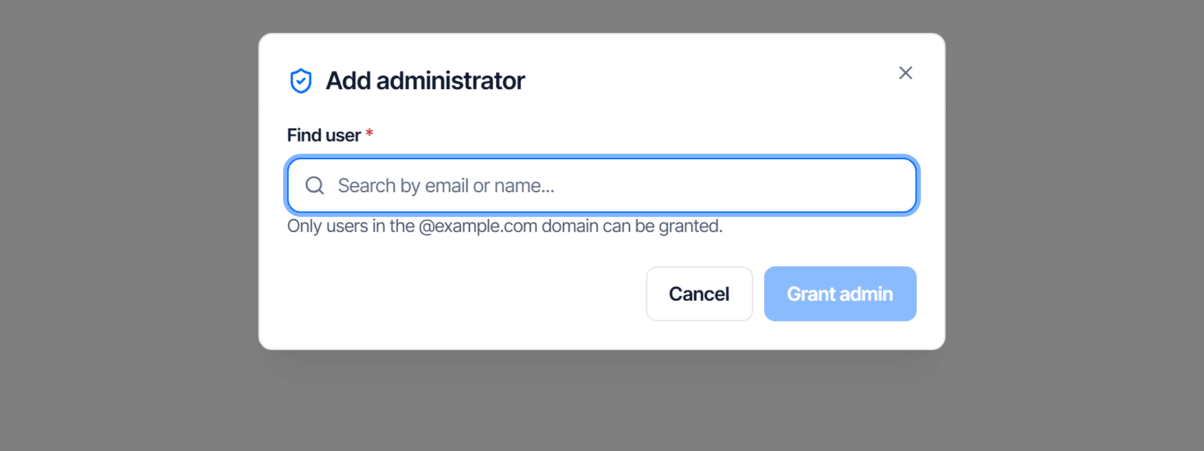 The Add administrator dialog: right under the title a note says only users in your domain can be granted, followed by the Find user field and a list of users with one person selected (highlighted, with a check mark), and at the bottom two buttons, Cancel and Grant admin