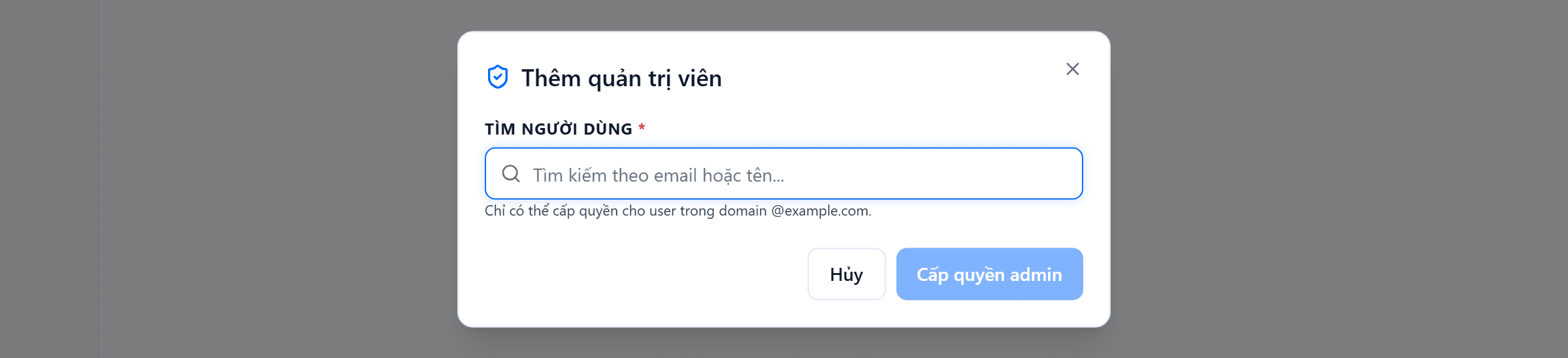 Hộp thoại Thêm quản trị viên chỉ có một ô nhập tên Tìm người dùng, gợi ý "Tìm kiếm theo email hoặc tên", bên dưới là dòng chú thích chỉ có thể cấp quyền cho user trong domain của bạn, và hai nút Hủy với Cấp quyền admin