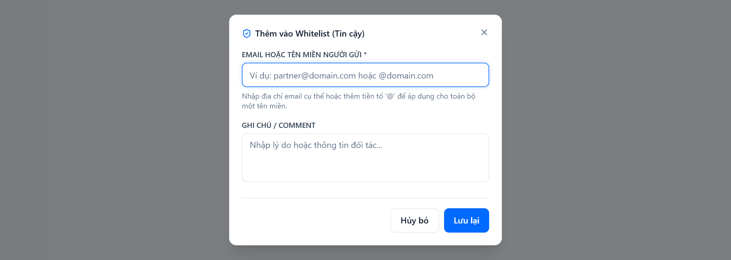 Hộp thoại Thêm vào Whitelist (Tin cậy): ô Email hoặc Tên miền người gửi kèm gợi ý nhập @ để áp cho cả tên miền, ô Ghi chú / Comment, và hai nút Hủy bỏ, Lưu lại